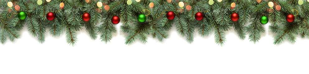 Fototapeta na wymiar New Year's decor from branches of a Christmas tree and New Year's toys with lights of light bulbs, snow and bokeh isolated on a white background, copy space