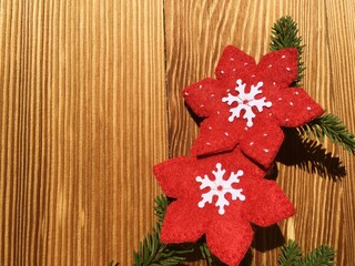 Red fabric snowflakes on wood backround