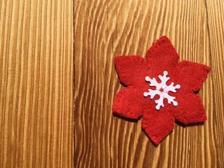 Red fabric flower on wood