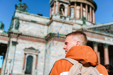 Rear view of a young man walking to St. Isaac's Cathedral in St. Petersburg