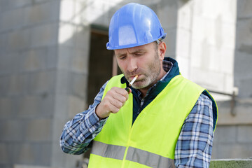 builder worker with a cigarette smoke break