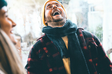 Young happy smiling guys wearing winter clothing having fun and laughing-portrait of couple sharing...