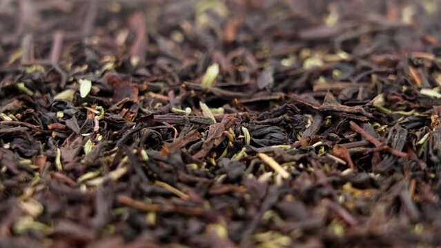 Dried black tea leaves with thyme herb. Dry healthful herbal healing ingredient. Rotation