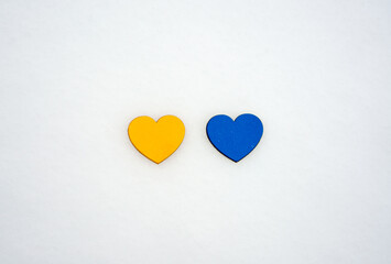 Yellow and blue hearts on a white snow