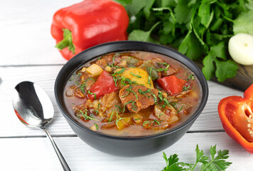 Georgian or Armenian meat khashlama with vegetables and spices on a white background. Selective focus.