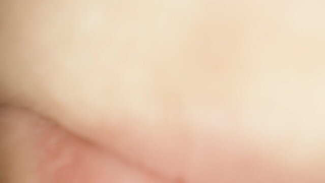A bunch of salty mini pretzels, a girl takes one and eats it, super close-up. POV