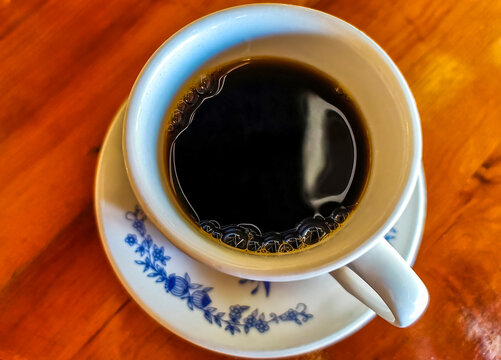 Blue white cup pot with black coffee wooden table Mexico.
