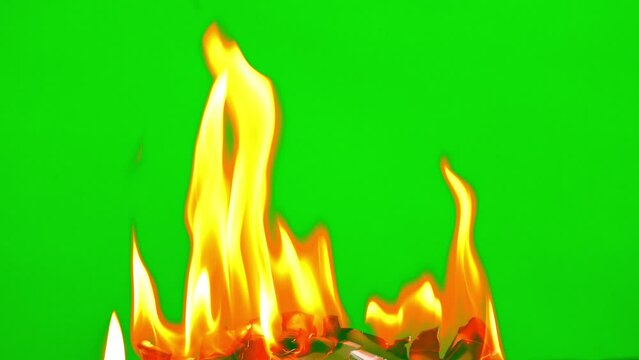 Fire flame burning white paper on green screen background