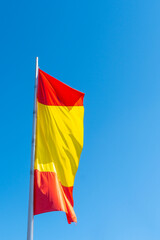 Spain flag with blue sky background