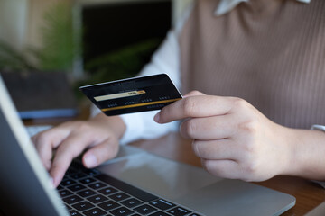 Women purchasing online using credit card payments via laptop, Shopping online and banking online concept.