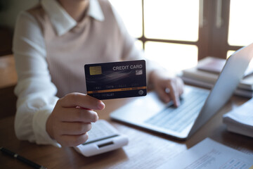 Women purchasing online using credit card payments via laptop, Shopping online and banking online concept.