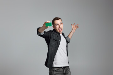 young man holding a credit bank card