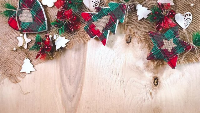 Christmas background with new year trees, stars, hearts and shimmering lights. New Year decorations on wooden background. Flat lay, top view. 
