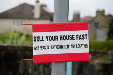 Sell your house fast sign outside residential area during property crisis - obrazy, fototapety, plakaty