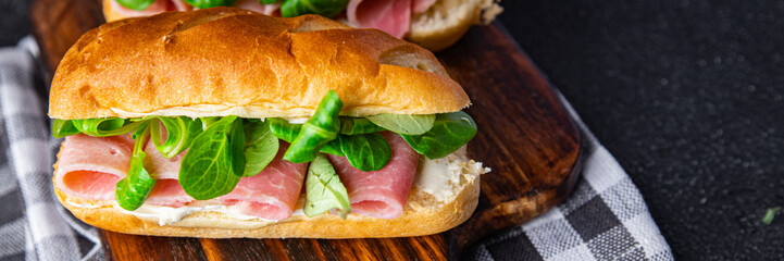 sandwich french milk buns ham, cheese, lettuce green leaves bio product fresh healthy meal food snack on the table copy space food background rustic top view