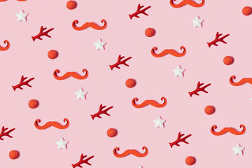 Red nose, antlers and star, traditional Christmas element, creative pattern against pastel pink background. 