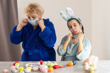 grandmother and granddaughter in masks for easter