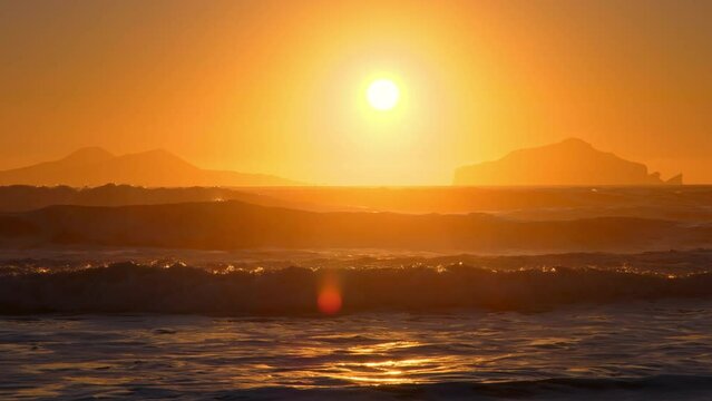 Sunrise over Stormy Sea, Shining Golden Waves with Sun Reflection at Sunset, Amazing light over Icelandic Nature, Shot in 8K Resolution 4320p
