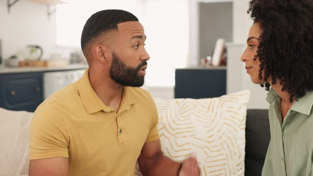 Argue, disagree and unhappy with a black couple talking in the living room of their home during a discussion. Communication, conversation and angry with a man and woman arguing on a sofa in the house