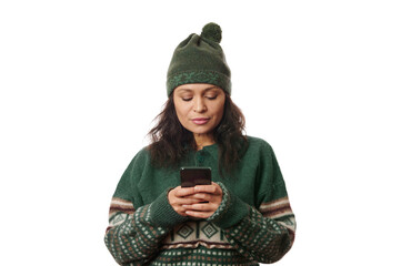 Charming young woman in warm clothes, using mobile phone, browsing web, checking social media...