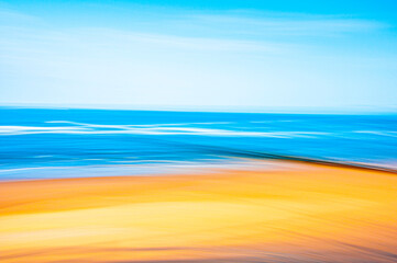 Abstract image of a serene empty beach with golden sand and azure blue water in summer
