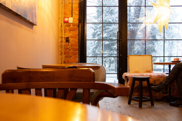 Cafe with a view of the snowfall from the window in Ukraine, the interior of the cafe with furniture