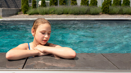 Young beautiful teenager girl in swimming pool