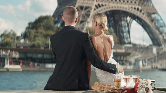 Elegant couple on date in Paris. Action. Luxurious couple on date with view of Paris tower. Eiffel Tower with beloved couple on sunny summer day