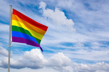 Gay Pride Flag over Blue Sky Background. 3D Illustration
