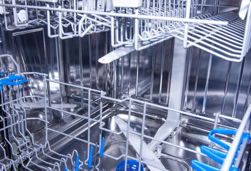 Obraz premium Interior of clean modern stainless steel dishwasher