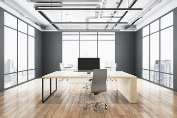 Front view on light work place table with modern computer, grey chair on wooden floor in spacious sunlit office with city view background from panoramic windows and dark walls. 3D rendering