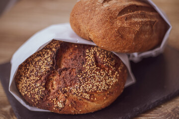 Fresh bread in a paper bag on a wooden table. The concept of natural products. gluten free bread.