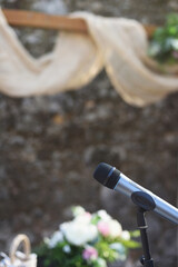 Sound microphone setup for a rural wedding ceremony, blurred background and selective focusing
