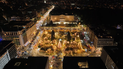 Aerial drone night shot from famous illuminated Syntagma square and Greek Parliament  building at Christmas, Athens historic centre, Attica, Greece
