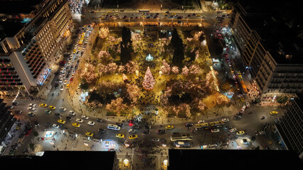 Aerial drone night shot from famous illuminated Syntagma square and Greek Parliament  building at Christmas, Athens historic centre, Attica, Greece