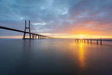 Fototapeta na wymiar Vasco da Gama bridge over tagus river in Lisbon, Portugal, at sunrise