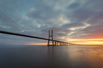 Naklejka na ściany i meble Vasco da Gama bridge over tagus river in Lisbon, Portugal, at sunrise