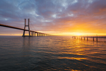 Fototapeta na wymiar Vasco da Gama bridge over tagus river in Lisbon, Portugal, at sunrise