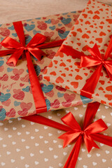 Romantic valentine day gift box for couple in love with heart ornament and red bow and silk ribbon.