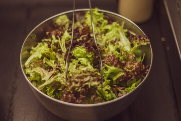Green vegan salad from green leaves mix and vegetables.