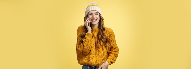 Carefree sociable good-looking outgoing woman calling friend talking happily smartphone have...