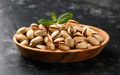 Pistachio shell nuts in wooden bowl. Healthy food