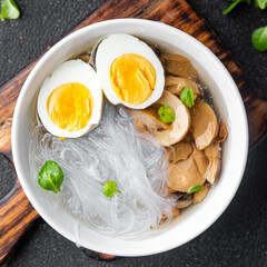 Fototapeta na wymiar Pho Bo asian soup rice noodles funchose, egg, mushrooms meal food snack on the table copy space food background top view