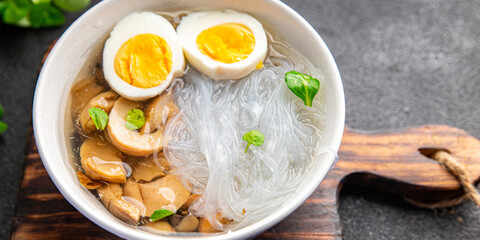 Pho Bo asian soup rice noodles funchose, egg, mushrooms meal food snack on the table copy space...