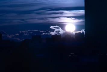 Sun setting behind apartment buildings.