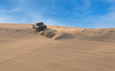 Desert Safari, a black SUV is bashing through the arabian sand dunes in Doha, Qatar © Arnold
