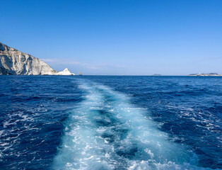 Wonderful weather, turquoise sea, a stone island and the small ship in the distance.