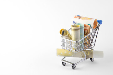 rolls of money in a shopping cart. Online store orders. free space for text. High quality photo