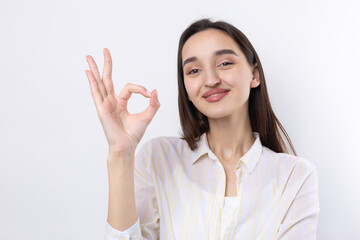 Smiling girl gesturing OK sign with her hand