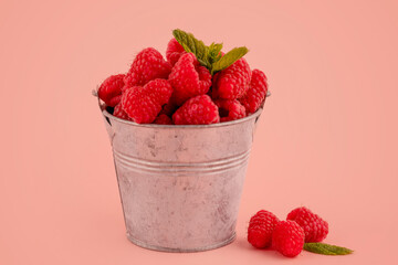 fresh raspberry in a cup on pink background